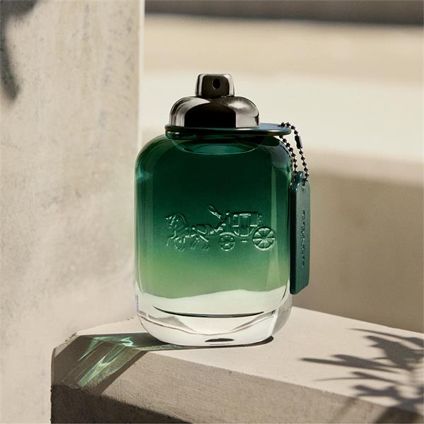 Coach Green perfume bottle with brand logo in an outdoor setting