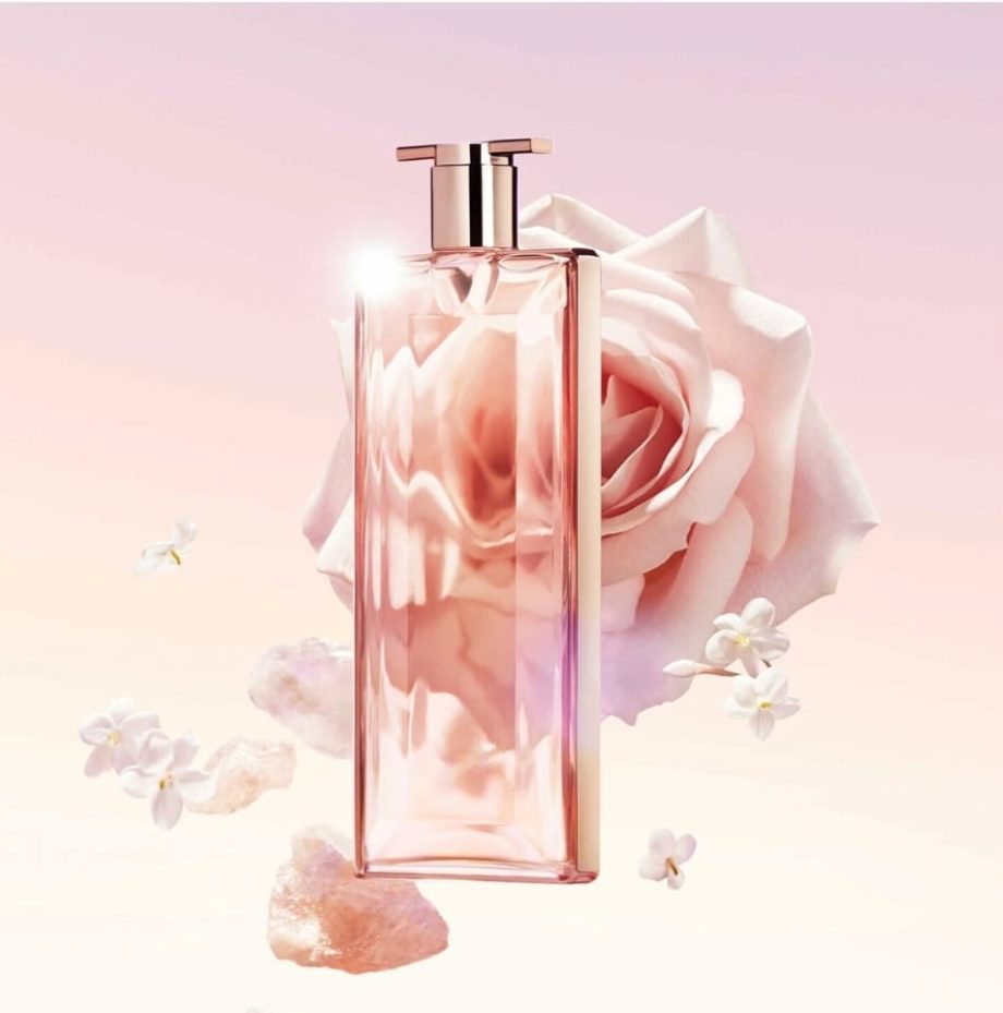 Lancôme Idôle fragrance displayed with rose petals and soft lighting