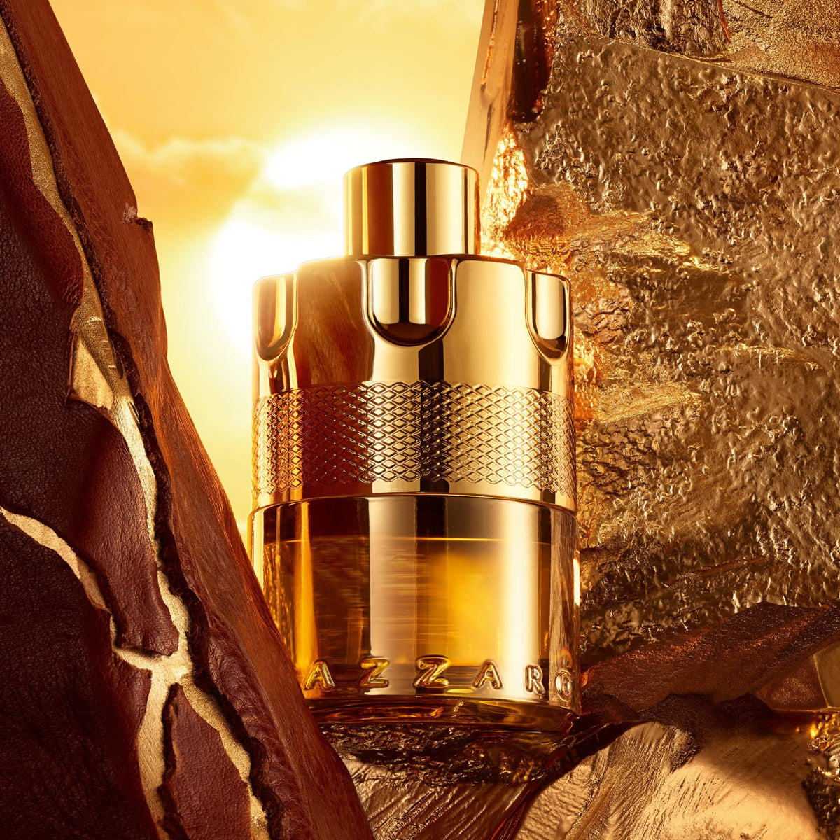 Gold Azzaro perfume bottle against a textured gold background