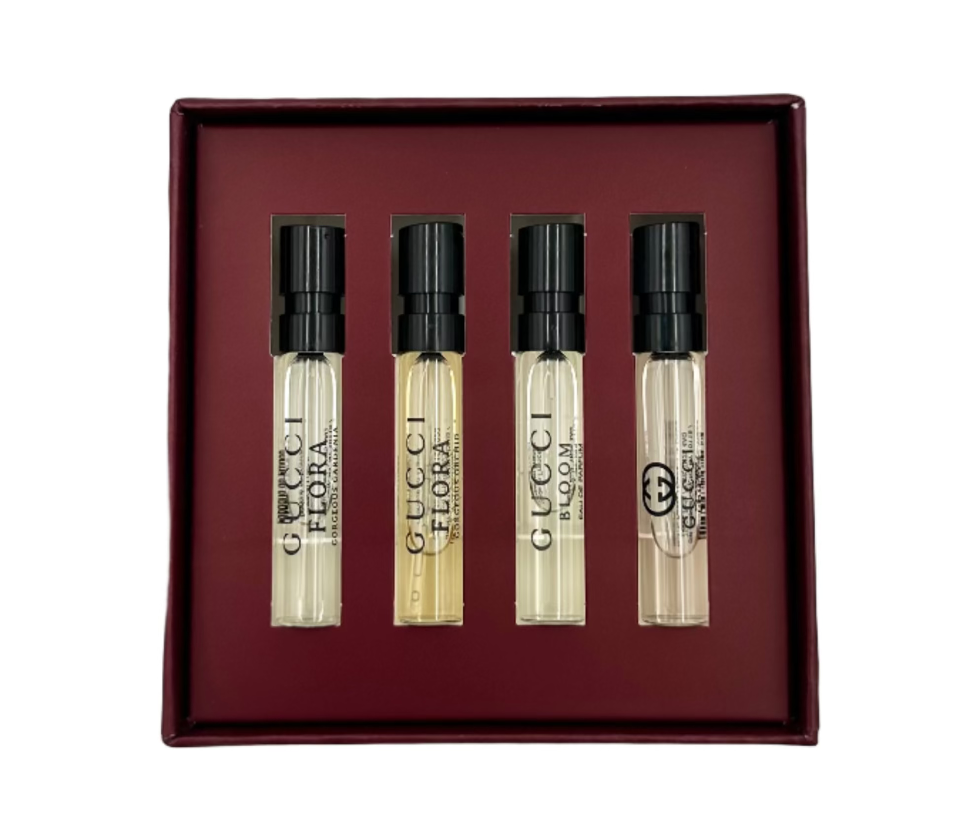 Set of four Gucci perfume miniatures in a box on a white background