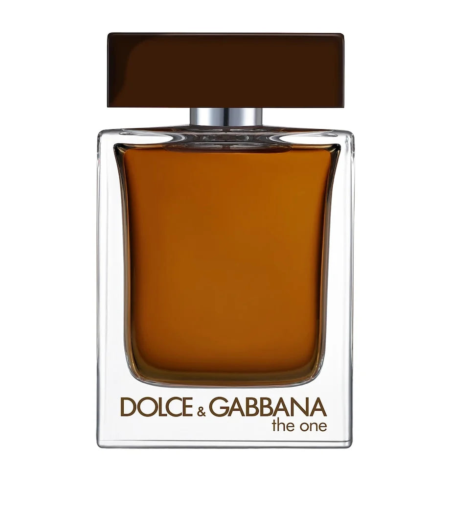 Dolce & Gabbana The One Eau de Toilette perfume bottle with amber-brown liquid, a dark brown rectangular cap, and gold lettering on a white background.