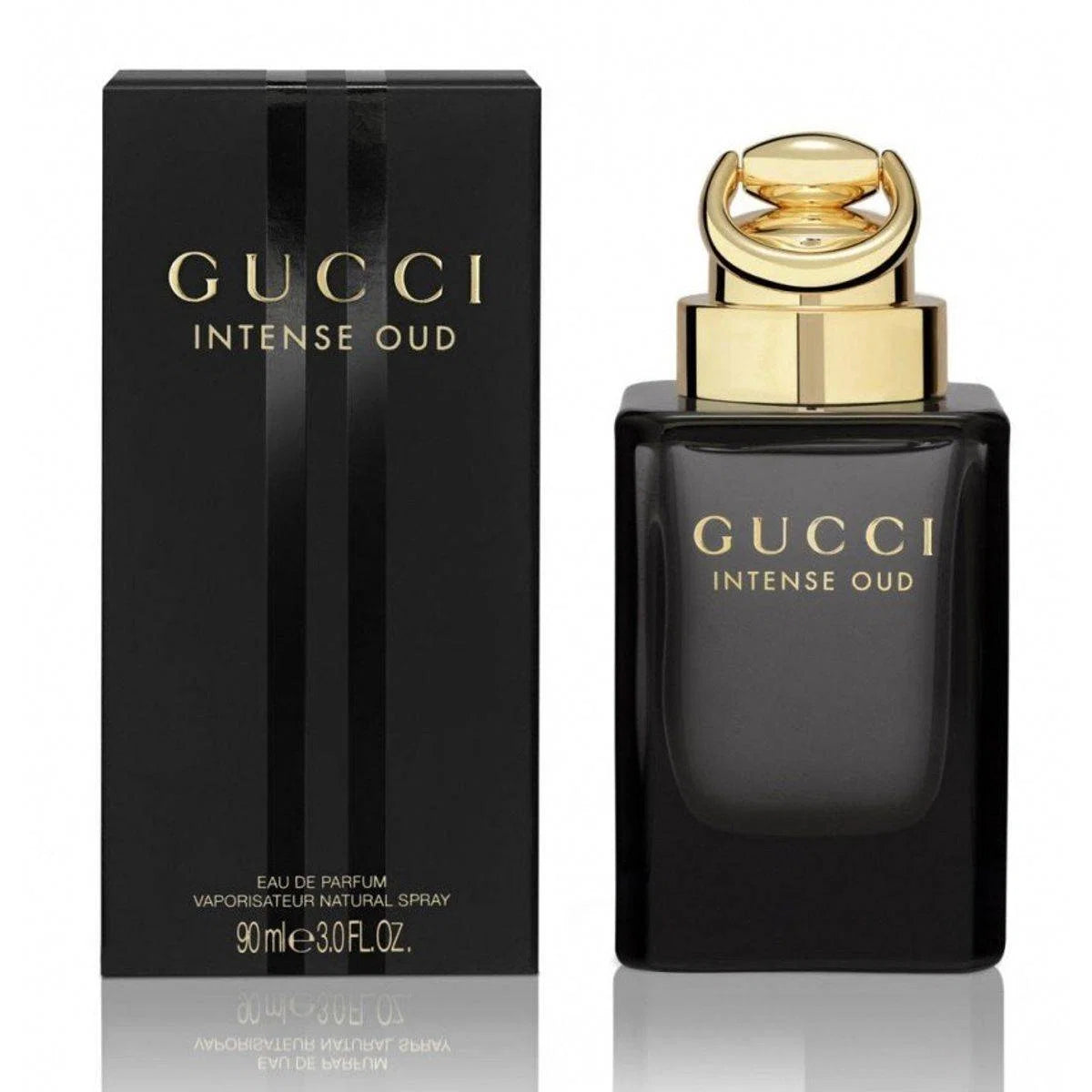 Gucci Intense Oud Eau de Parfum bottle and its black packaging box, both featuring gold lettering and a gold cap, set against a white background with a subtle reflection.