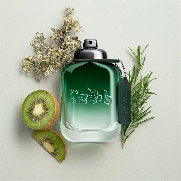 Coach Green perfume bottle with kiwi slices and herbs