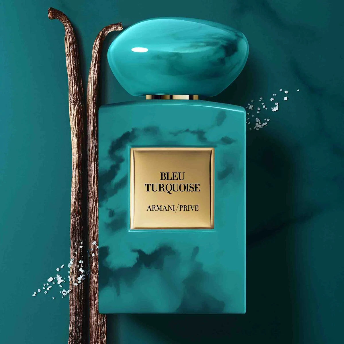 Armani Privé Bleu Turquoise perfume bottle with a turquoise marble pattern and a gold label, styled with vanilla pods on a matching turquoise marble background.