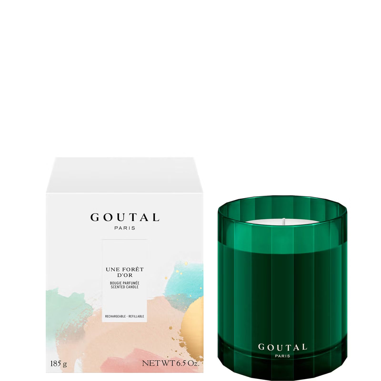 Goutal 'Une Forît D’or' scented candle in a faceted dark green glass jar next to its white packaging box with pastel paint splatters.