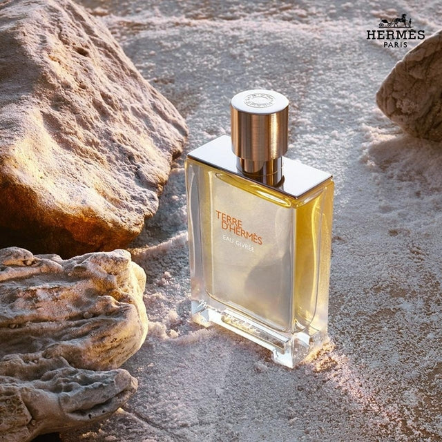 Hermes Terre d'Hermès Eau Givrée Eau De Parfum 5ml perfume bottle on sand with rocks around