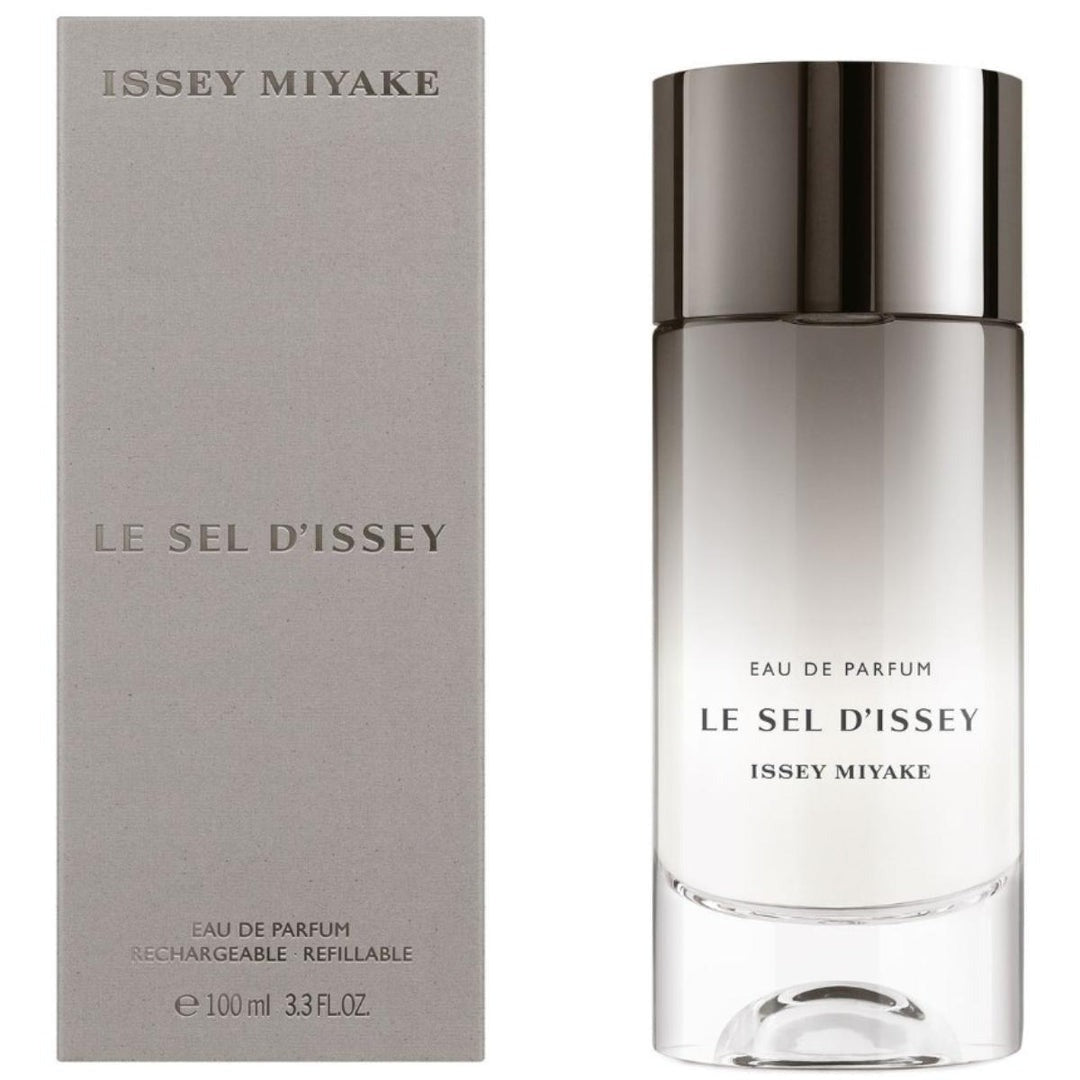 Issey Miyake Le Sel D'Issey Eau de Parfum bottle next to its grey packaging box, featuring a reflective silver cap and clear glass body.