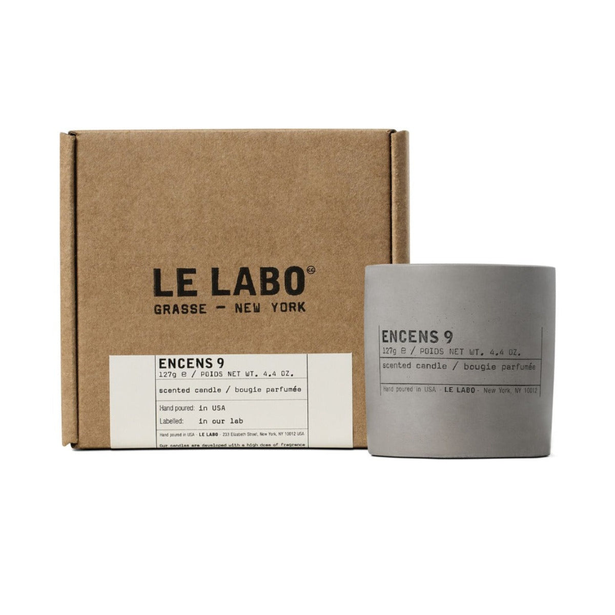 A Le Labo Encens 9 scented candle in a matte gray concrete jar next to its brown kraft paper packaging box, both featuring black text on a clean white background.